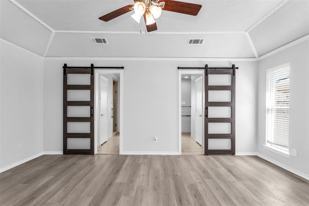 7233 Rustic Valley Drive Dallas, TX 75248 - Photo 11 of 21 an empty room with wooden floor closet and windows