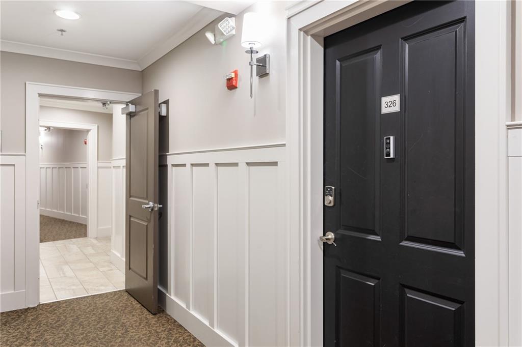 2255 Peachtree Road Northeast, Unit 326 Atlanta, GA 30309 - Photo 20 of 37 a view of a hallway with wooden cabinets