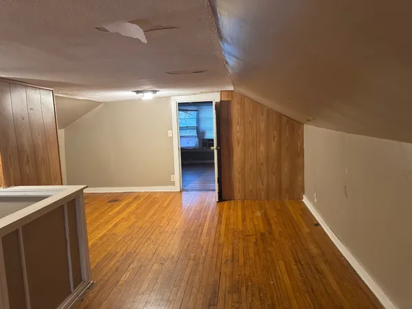 a view of wooden floor and brick walls