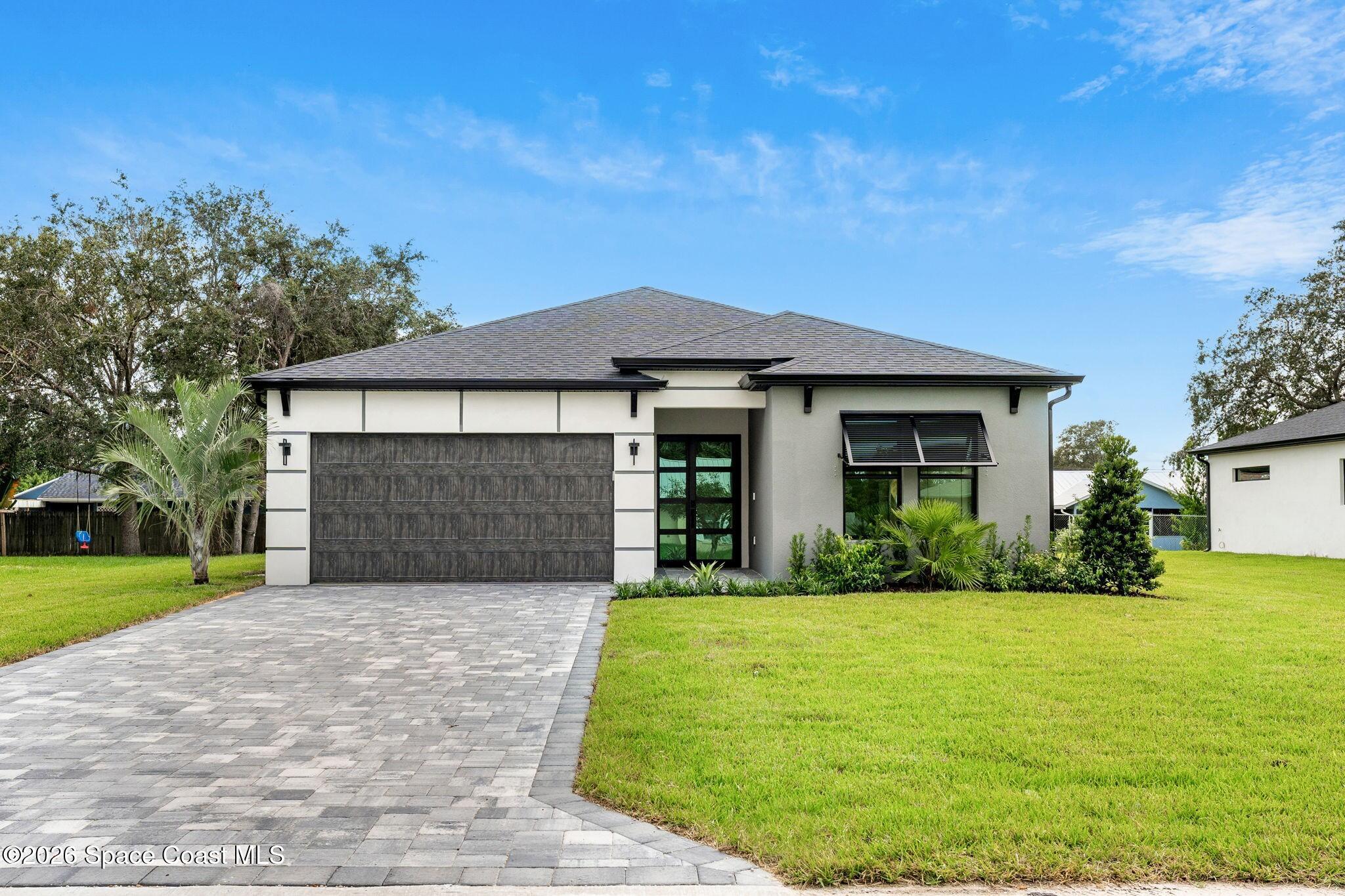 a front view of house with yard and green space