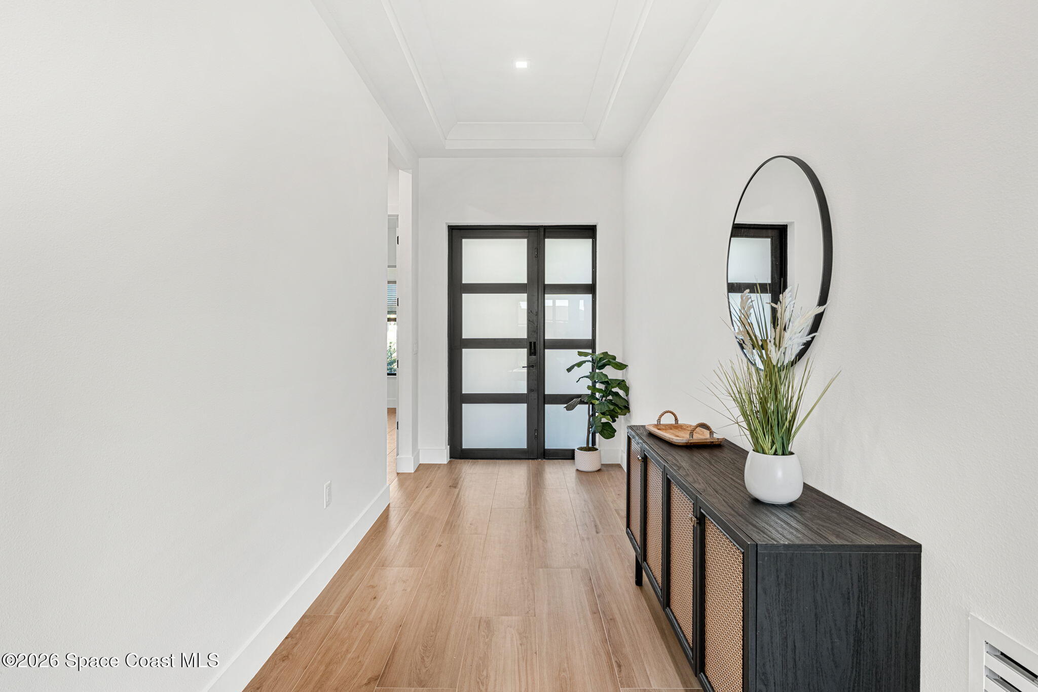 4555 Kings Highway Cocoa, FL 32927 - Photo 2 of 12 a view of a hallway with wooden floor and a potted plant