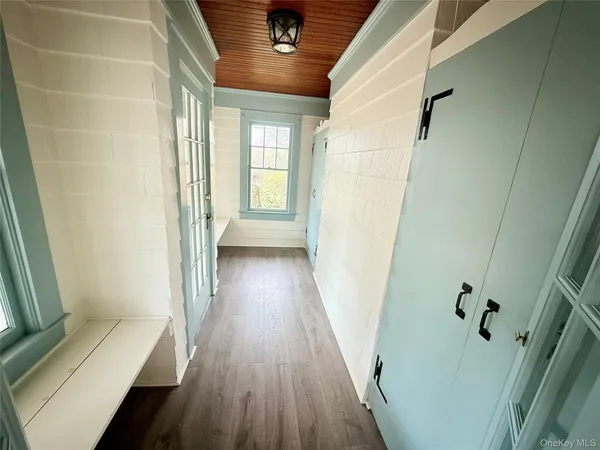 a view of a hallway with wooden floor and staircase