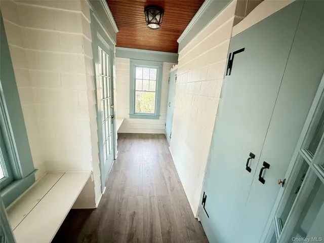 a view of a hallway with wooden floor and staircase