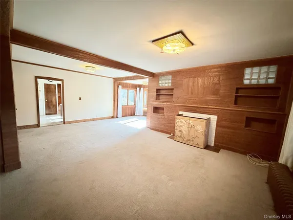 a large room with closet and windows