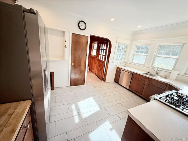 a kitchen with stainless steel appliances a refrigerator and a stove top oven