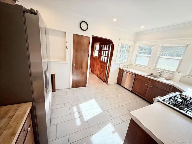a kitchen with stainless steel appliances a refrigerator and a stove top oven