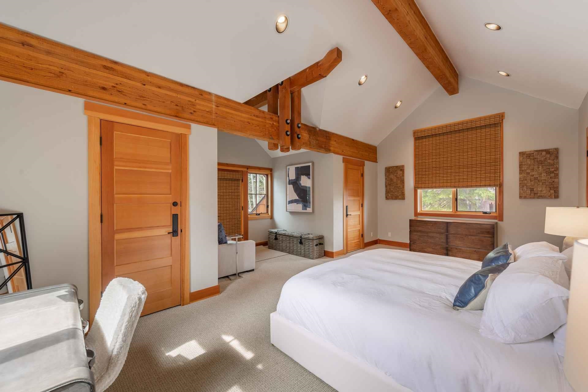 1723 Grouse Ridge Road Truckee, CA 96161 - Photo 21 of 21 a bedroom with a large bed a chandelier and dresser