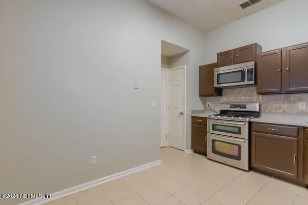 a kitchen with a refrigerator stove and microwave