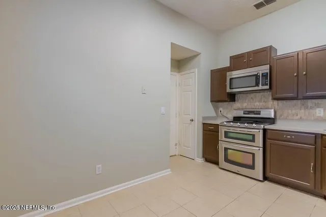 a kitchen with a refrigerator stove and microwave