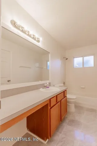 a bathroom with a sink a toilet and bathtub
