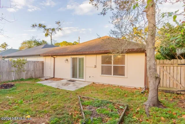 a front view of a house with a yard outdoor seating and garage