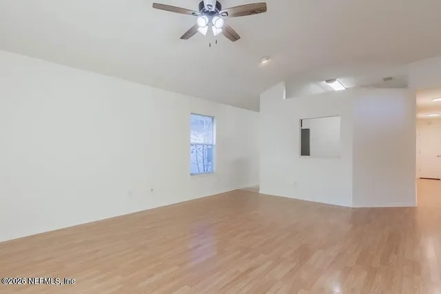 wooden floor in an empty room with a window
