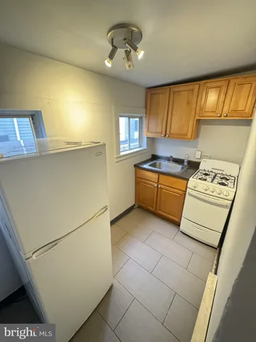 a kitchen with stainless steel appliances a stove a sink and a refrigerator