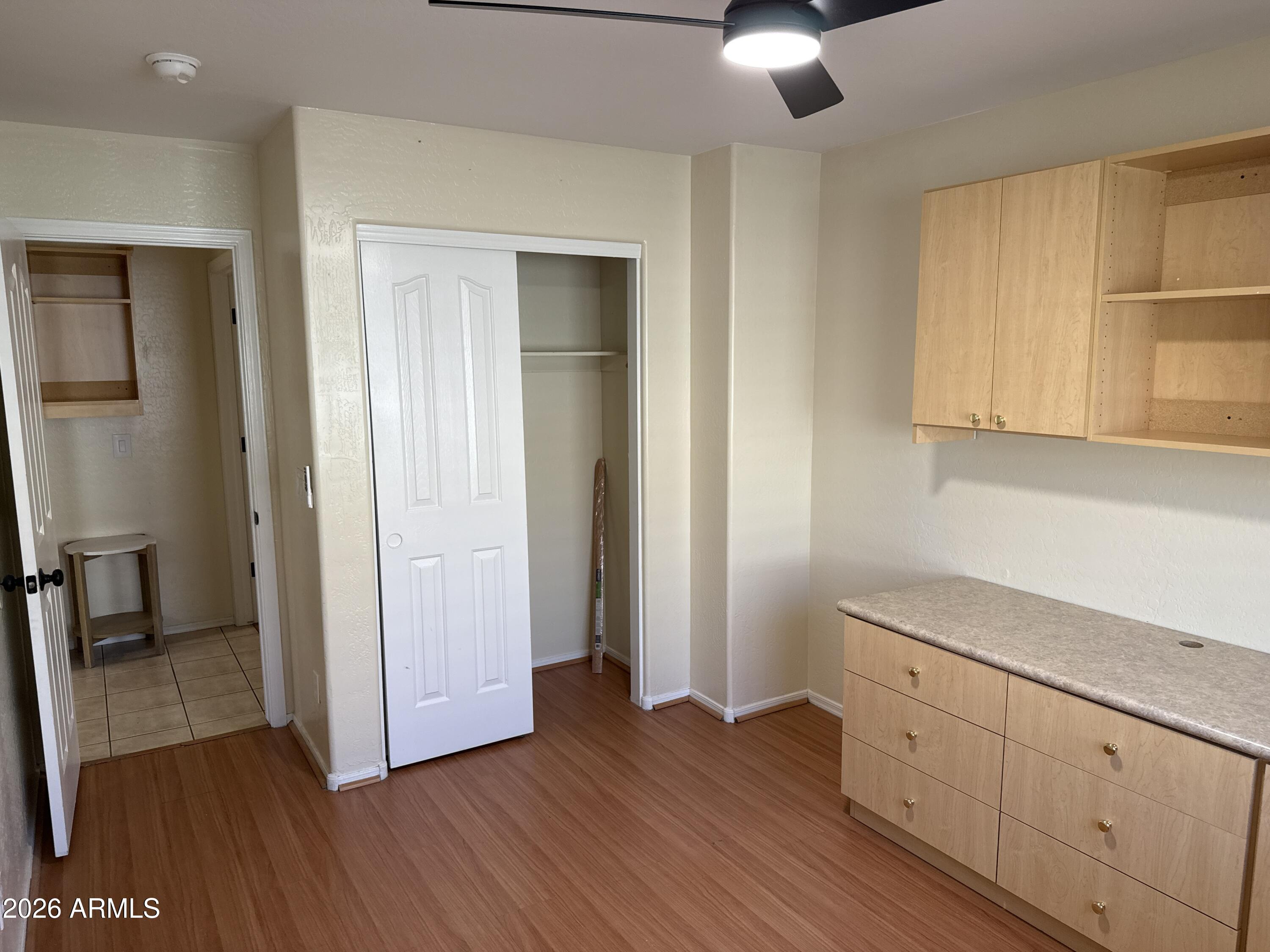 9630 West Reno View Drive Peoria, AZ 85345 - Photo 17 of 21 an entryway with wooden floor and cabinet