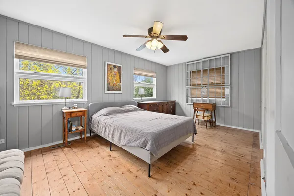 a spacious bedroom with a bed and a table in it