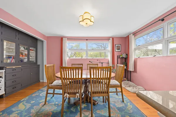 a view of a dining room with furniture window and wooden floor