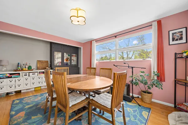 a dining room with a table chairs and kitchen view