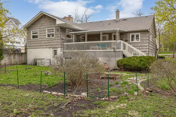 a front view of a house with plants and garden