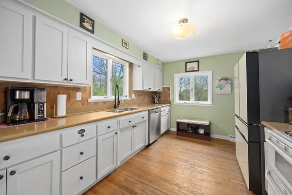 a kitchen with sink cabinets and window