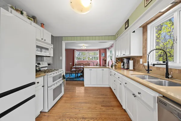 a kitchen with sink cabinets and wooden floor