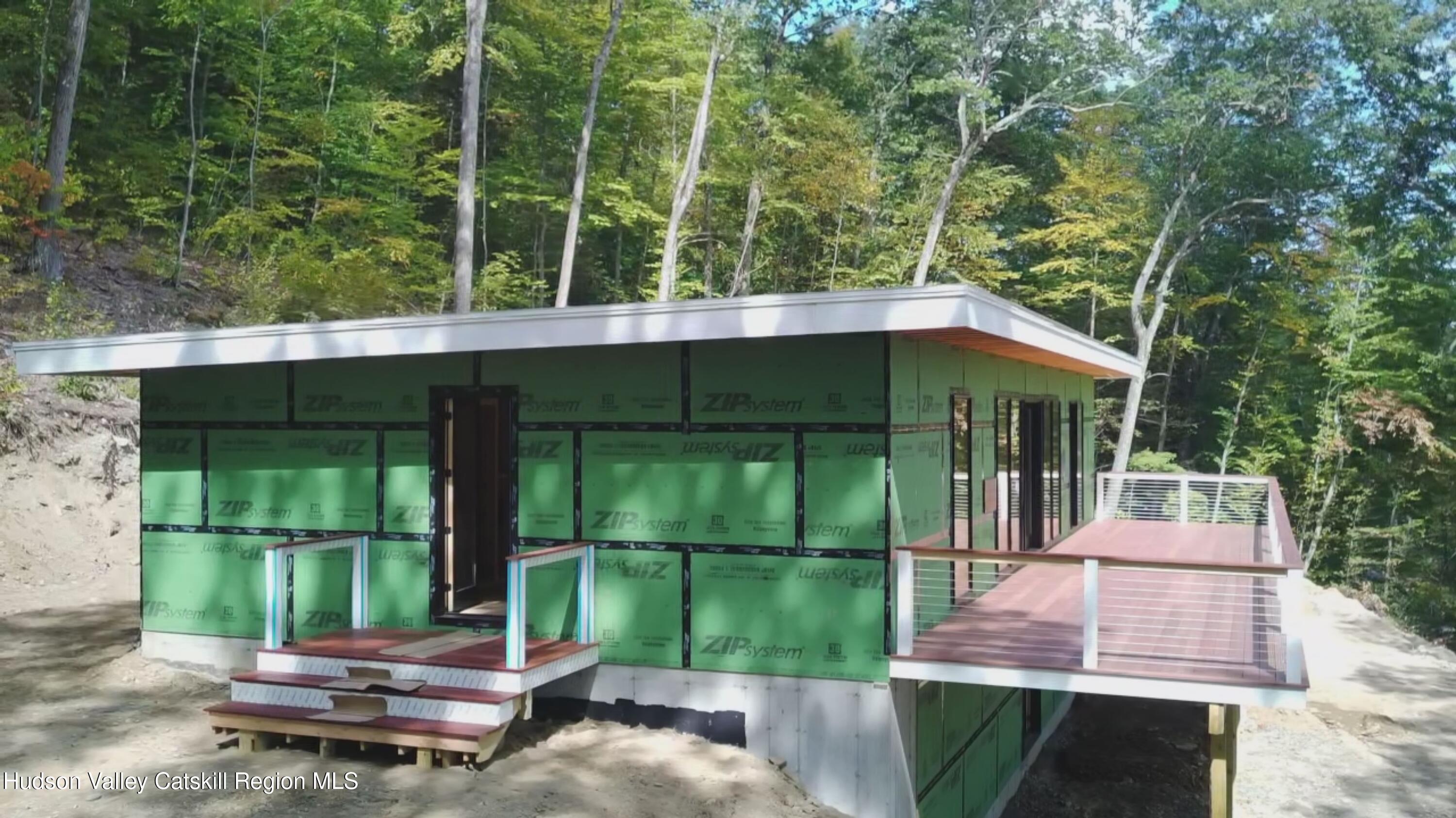 801 Rodman Road Hillsdale, NY 12529 - Photo 9 of 25 a backyard of a house with a garden and deck