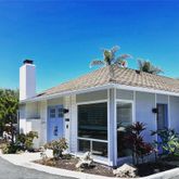 a view of a house with potted plants