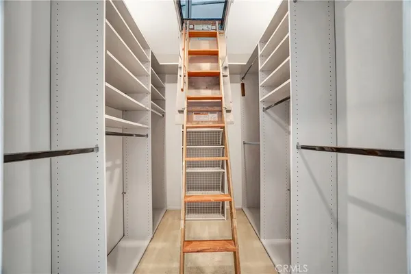 a view of walk in closet with empty racks