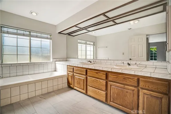 a large bathroom with a large tub and sink