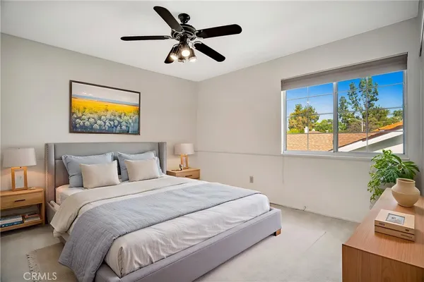 a bedroom with a bed and a painting on the wall