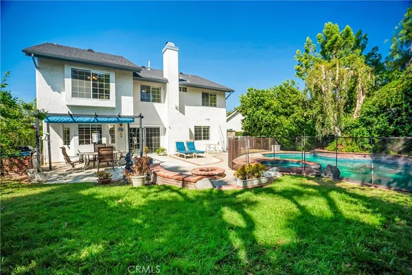 a house view with a sitting space and garden
