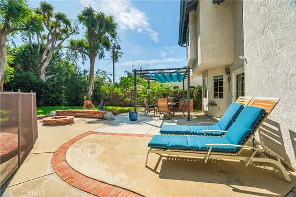a view of a patio with a table and chairs under an umbrella