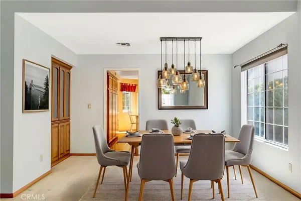 a dining room with furniture and window