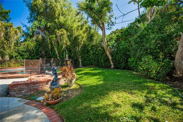 a view of a house with backyard sitting area and garden