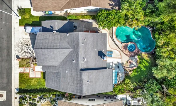 an aerial view of a house with garden space and lake view
