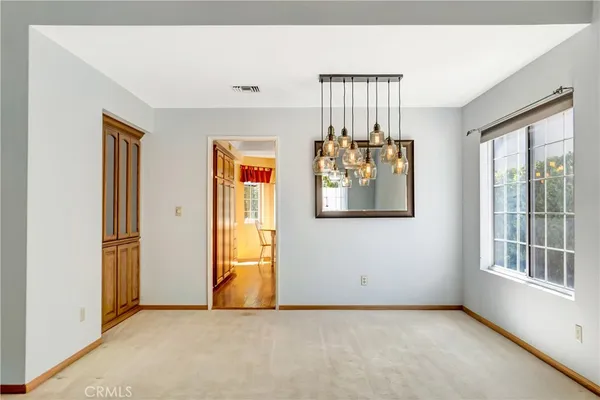 an empty room with windows and closet