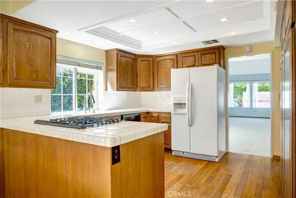 a kitchen with stainless steel appliances granite countertop a refrigerator and a sink