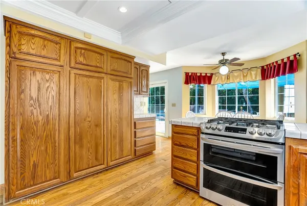 a kitchen with granite countertop wooden cabinets and stainless steel appliances