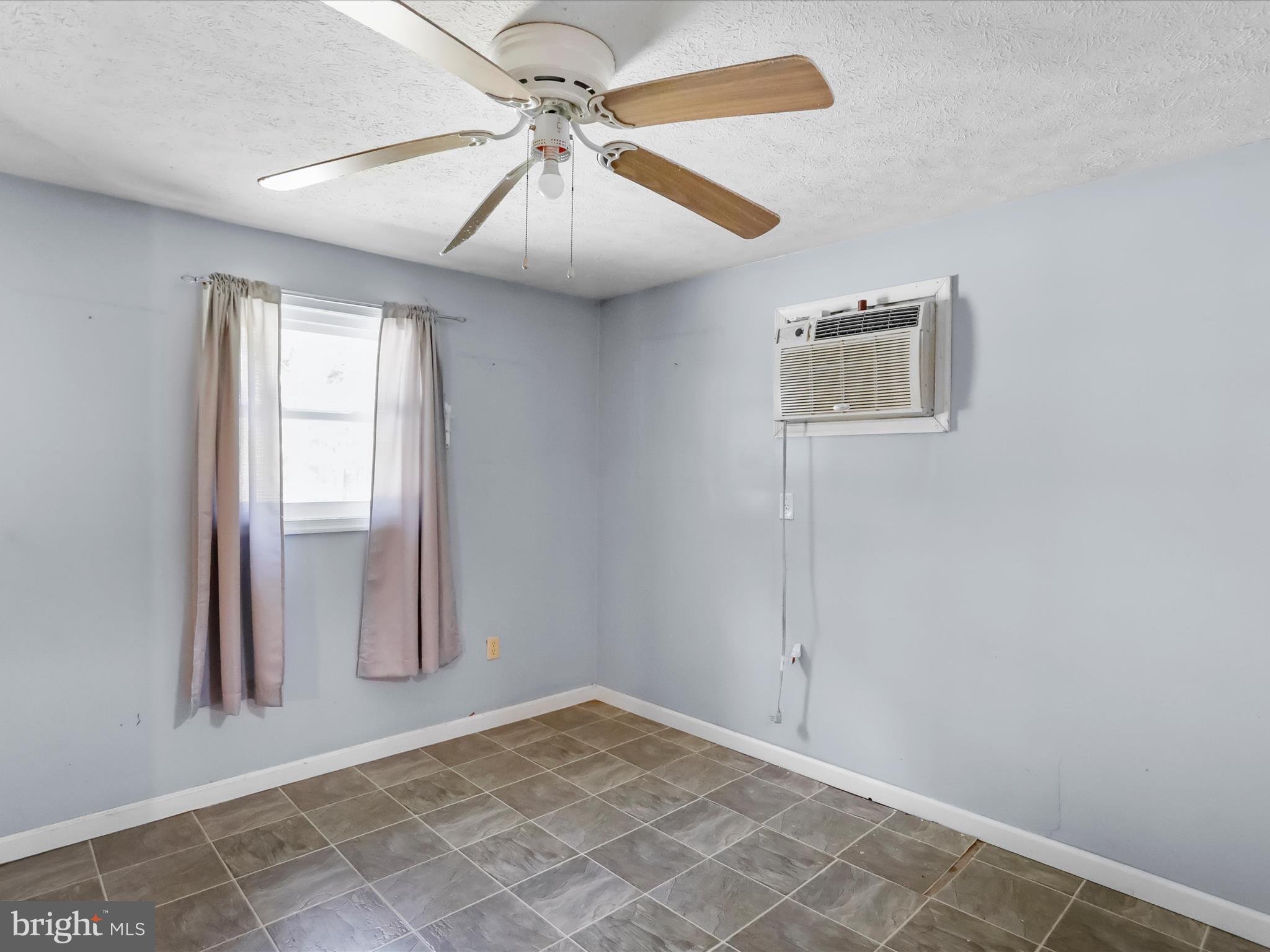 867 Mason Road Hedgesville, WV 25427 - Photo 18 of 39 an empty room with windows and fan