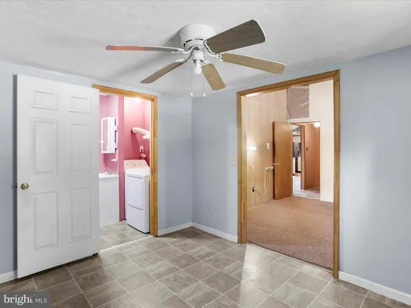 a bathroom with a shower curtain sink and a toilet