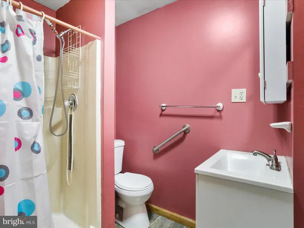a bathroom with a sink mirror and a shower