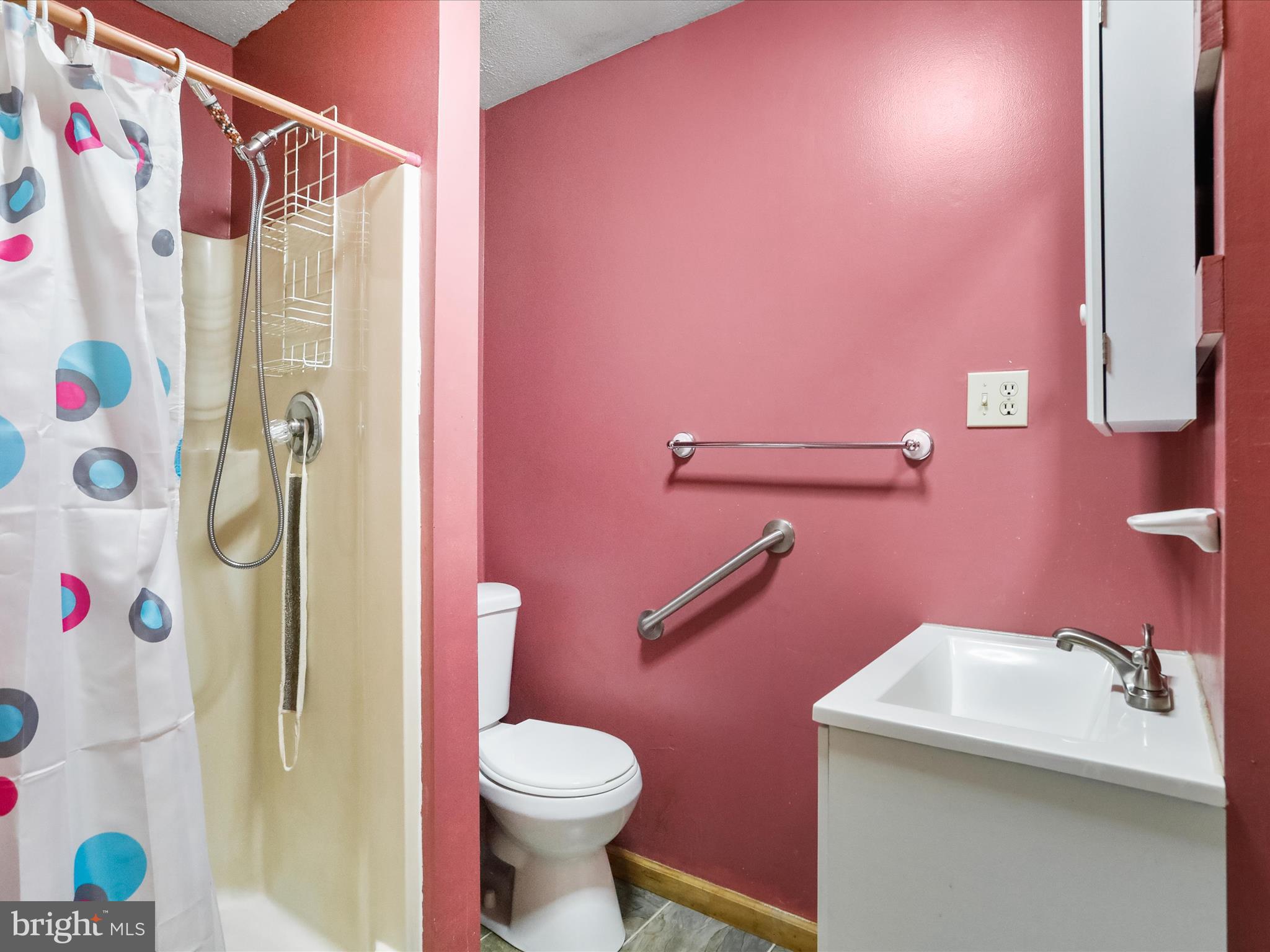 867 Mason Road Hedgesville, WV 25427 - Photo 21 of 39 a bathroom with a shower curtain sink and a toilet