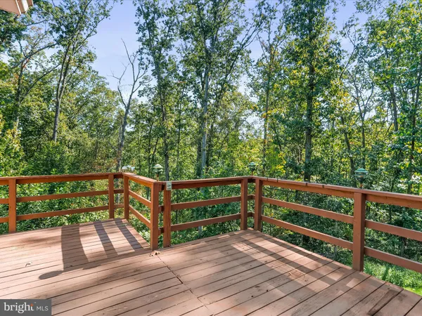 a view of backyard of house with wooden fence