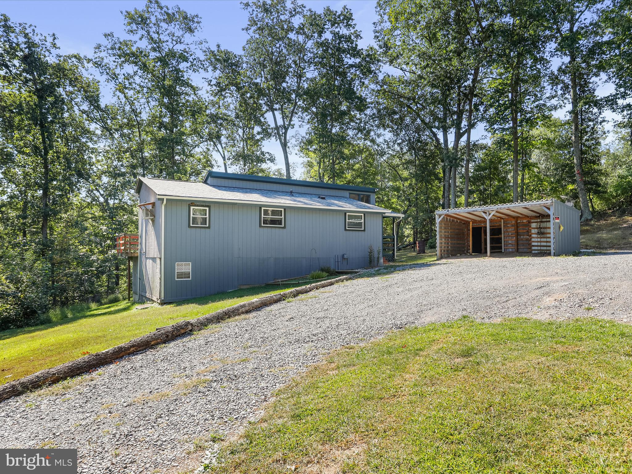 867 Mason Road Hedgesville, WV 25427 - Photo 31 of 39 a backyard of a house with large trees and wooden fence