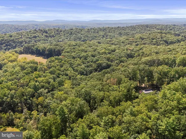 a view of a wooden house with a yard