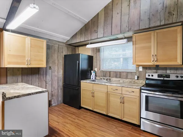 a kitchen with a sink stove and refrigerator