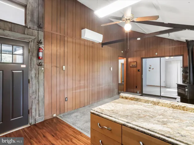 a view of a hallway with wooden cabinet