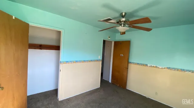 a view of a hallway with a ceiling fan