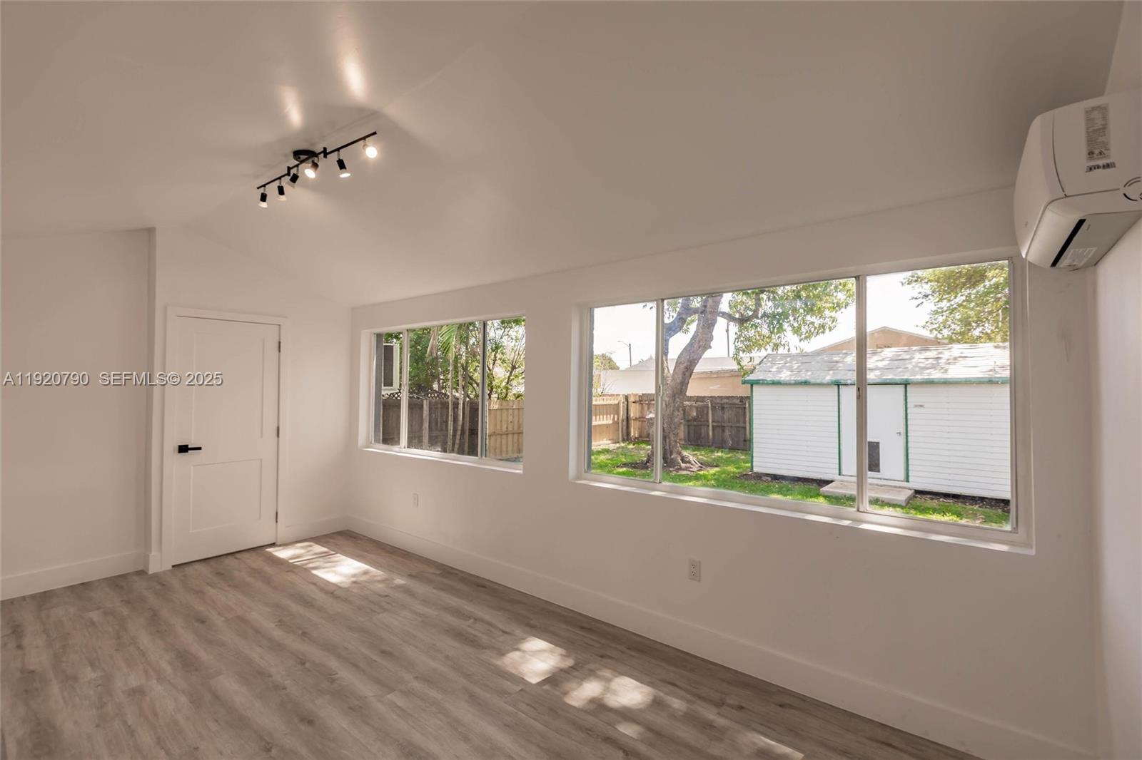 3180 Northwest 2nd Street Miami, FL 33125 - Photo 19 of 29 an empty room with wooden floor and windows