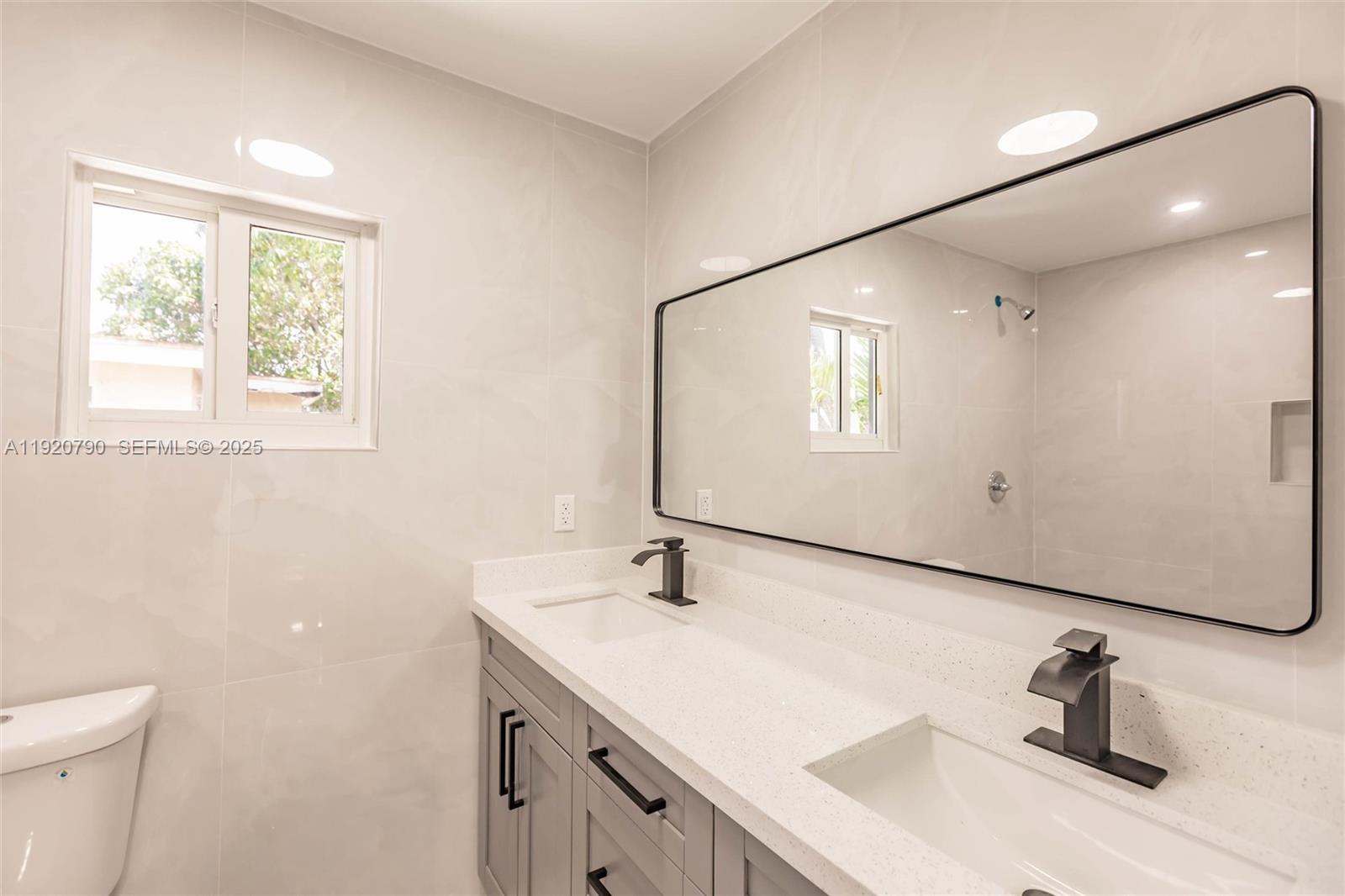 3180 Northwest 2nd Street Miami, FL 33125 - Photo 20 of 29 a bathroom with a sink and a mirror