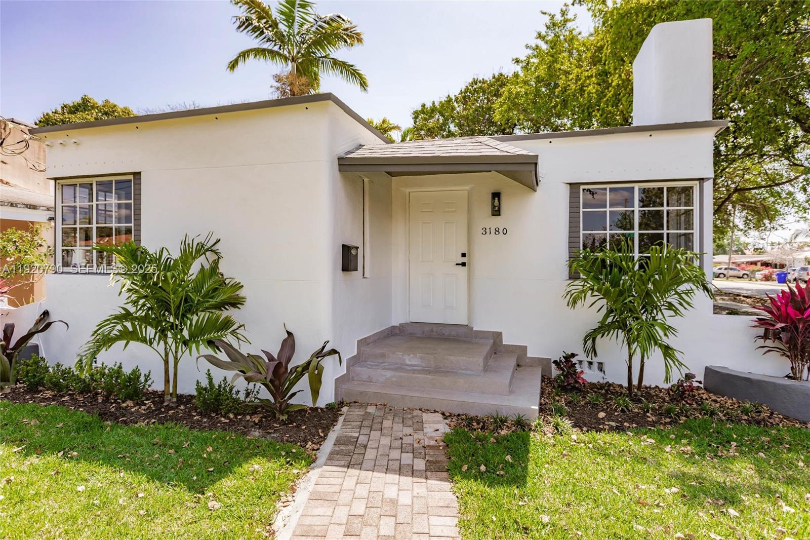 3180 Northwest 2nd Street Miami, FL 33125 - Photo 2 of 29 a front view of a house with garden